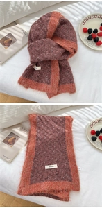 Detailed knit texture and stitched label of this warm winter scarf with fringes