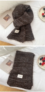 Detailed macro view of soft dark brown striped fuzzy scarf with premium knit texture