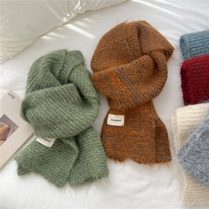 Two-tone chunky knit scarf with soft mohair-like texture and minimalist brand label