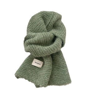 Two-tone sage green knit scarf with soft wool texture and minimalist brand label
