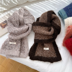 Cozy bicolor knitted scarf for winter with soft texture on a white background