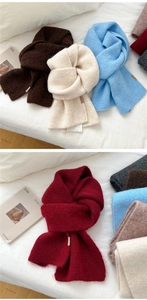 Detail of soft knitted texture and minimalist label on multi-color winter scarves