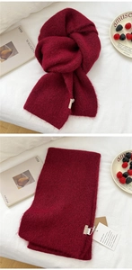 Detail of dark red knit scarf showing soft mohair texture and premium brand woven label