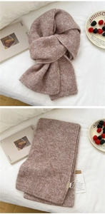 Close-up of thick light brown chunky knit scarf with plush wool texture and brand label