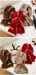Detail of chunky knit scarf showing contrast stitching and premium soft texture