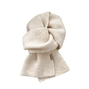 Solid beige knitted wool scarf for winter featuring minimalist brown leather logo patch