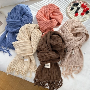 Soft knit fringe scarf in blue pink and beige tones for winter warmth and comfort
