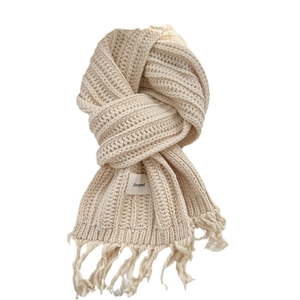 Knitted beige fringe scarf with textured vertical patterns and a branded woven label