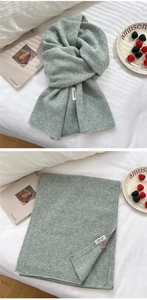 Detail of light green 100% pure wool knitted scarf with soft colorful flecked texture