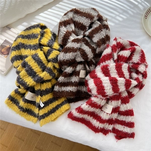 Three striped knitted winter scarves in yellow, brown, and red with cozy mohair texture