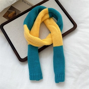 Close-up of yellow and teal color-block knit scarf with soft ribbed texture detail
