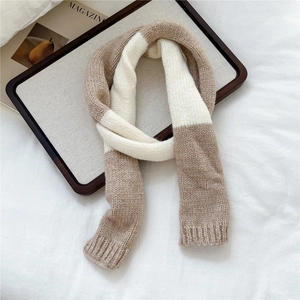 Close-up of contrast color knit scarf with thick stitching and ribbed edge detail