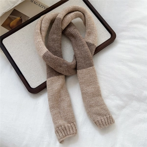 Close-up of contrast knit scarf texture in khaki and brown with ribbed edge finish