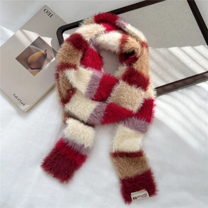 Macro detail of plush checkered scarf texture with vintage red and brown patterns