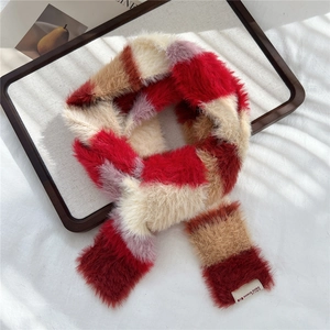 Close-up of fluffy striped scarf showing soft faux fur texture and brand label detail
