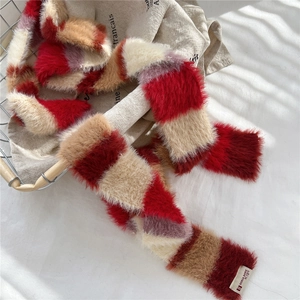 Detailed close-up of colorful striped plush scarf with soft texture and brand label