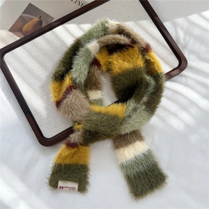 Macro detail of plush faux fur striped scarf with DORIA DORE designer brand label