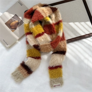 Macro detail of the plush faux fur texture and striped design of the winter scarf