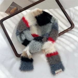 Detail of colorful striped plush scarf with woven brand label on soft faux rabbit fur
