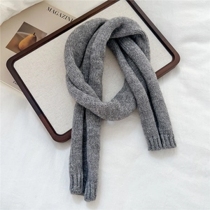 Detailed macro view of grey thick knit scarf showing premium woven texture and fiber details
