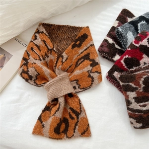 Leopard print knitted neck warmer scarf with crossover closure in orange and brown tones