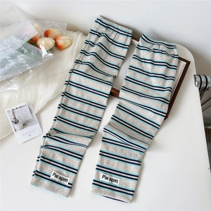 Close-up of striped knitted cooling sleeves with brand patch on white aesthetic background