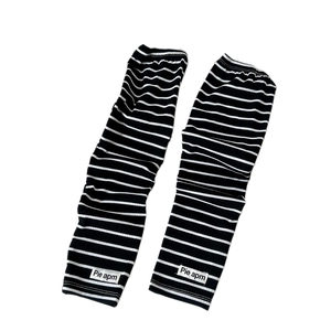 Striped sun protection cooling sleeves with knit texture and brand label in black and white