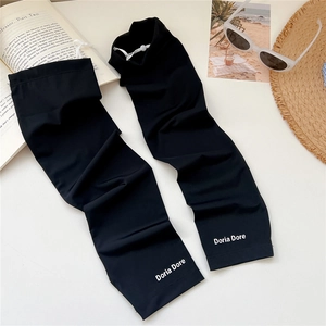 Detail of black cooling sun sleeves with adjustable drawstring and silk touch texture