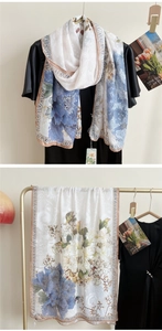 Détail d'un long châle à imprimé floral bleu avec des bordures à motifs vintage