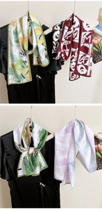 Close-up of four printed silk neck scarves with various artistic leaf and geometric patterns