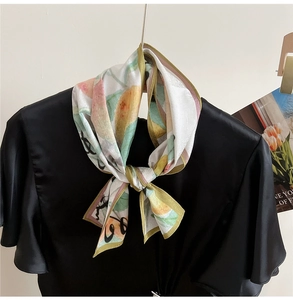 Close-up of a multi-color abstract print silk scarf tied as a stylish neck accessory