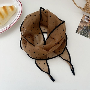 Close-up of a brown polka dot semi-transparent scarf neatly arranged on a white background