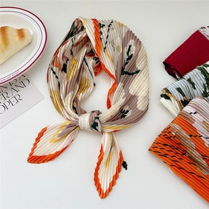 Pleated square silk scarf with floral patterns in a stylish French lifestyle setup