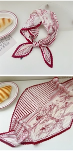 Detail of red floral pleated scarf showing folded texture and artistic lifestyle styling