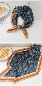 Detail of pleated paisley scarf showing vintage floral pattern and wavy edge finishing