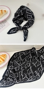 Detail of black and white polka dot pleated scarf with elegant geometric patterns