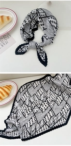 Detail of pleated silk square scarf with black and white geometric polka dot pattern
