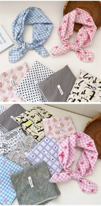 Flat lay of cotton square scarves with floral and plaid patterns on white background
