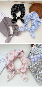 Detail of various cotton scarves with polka dots and floral prints on a white table