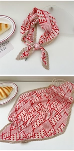 Detail of pleated silk scarf with red polka dots and khaki edges in a lifestyle setting