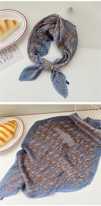 Macro view of blue paisley pleated silk scarf with fine accordion fold texture