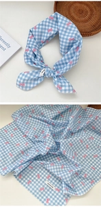 Close-up of 100% cotton blue plaid scarf with pink bow prints and high-quality stitching