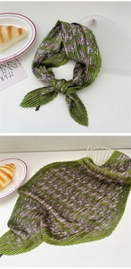 Detail of pleated green paisley silk scarf with vintage pattern and micro-crinkle texture