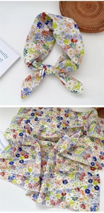 Detail of 100% cotton floral daisy scarf showing soft fabric texture and tie-knot style