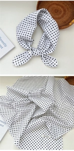 Detailed view of 100% cotton black and white polka dot scarf with woven texture
