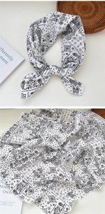 Detail of white cotton paisley bandana showing classic bohemian print and texture