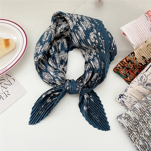 Pleated square scarf with navy and white paisley print on minimalist background