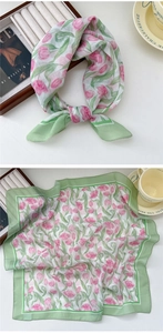 Detail of pink tulip floral silk scarf with green borders tied in a delicate bow