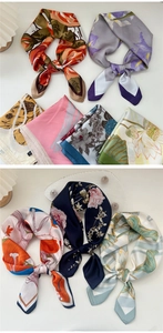 Detailed view of various floral silk neck scarves in elegant satin finish and prints
