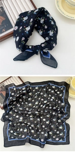 Detail of floral black cotton linen square scarf with blue border and delicate patterns